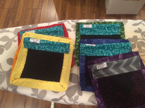 6 quilts, veiewed from the back with quilt sleeves attached